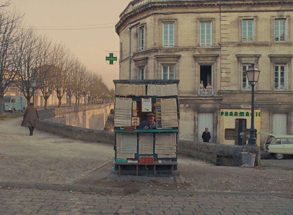 Still image from The French Dispatch of a news stand on a street