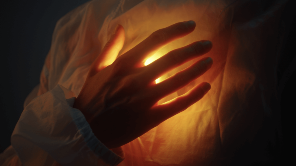 hand on glowing heart