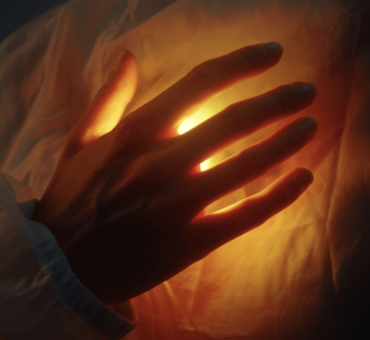 hand on glowing heart