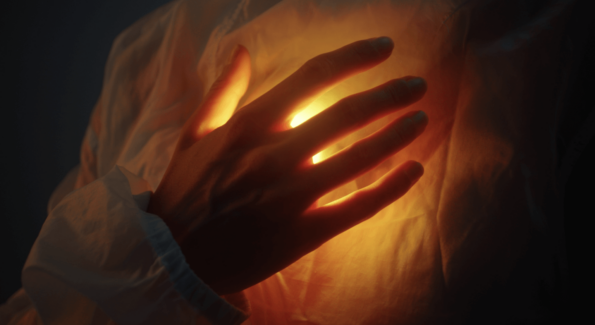 hand on glowing heart