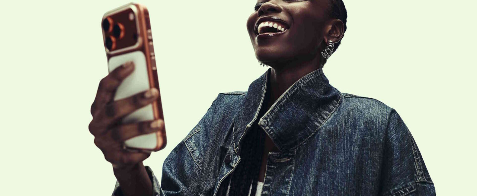 Young woman laughing at an ad on her smartphone