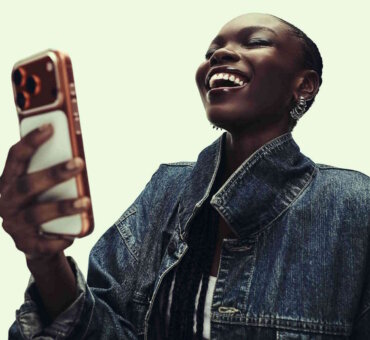 Young woman laughing at an ad on her smartphone
